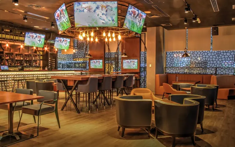 Restaurant bar and dining room with TV screens