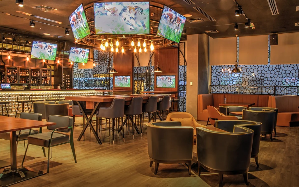 Restaurant bar and dining room with TV screens